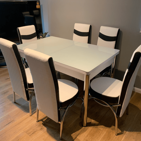 WHITE TABLE WITH WHITE AND BLACK CHAIRS